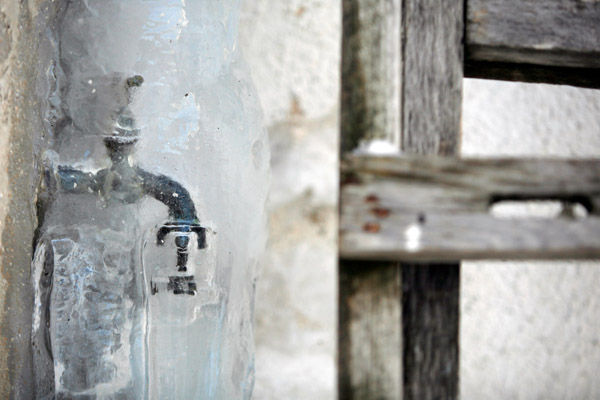 outdoor faucet covered in ice