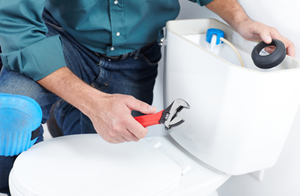 image of Emmaus plumber doing a toilet repair