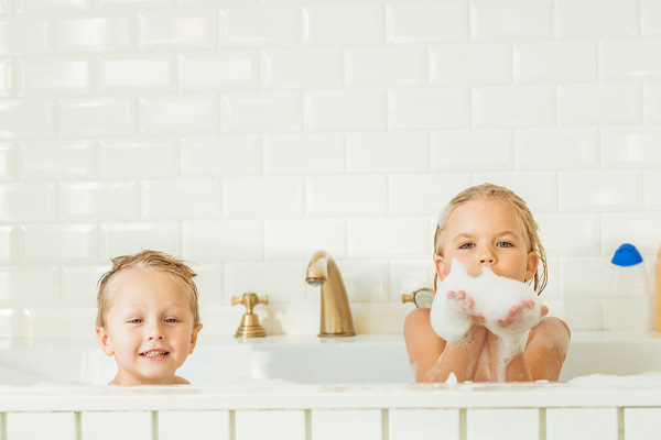  image of kids playing in bathtub depicting clean water with on-demand water heater