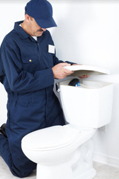 image of plumber repairing toilet