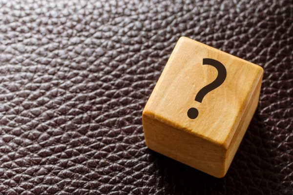 question mark on a wooden cube depicting FAQs