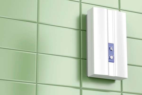 tankless water heater against green bathroom tiles