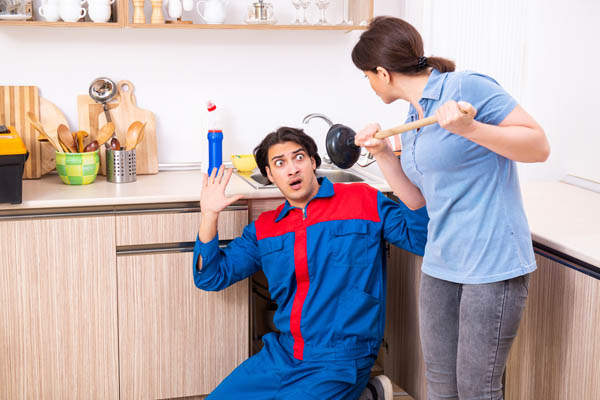 image of a plumber fixing the sink
