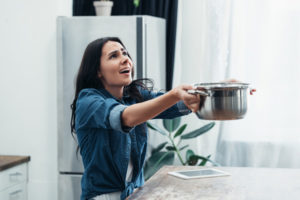 image of a homeowner dealing with an emergency plumbing problem