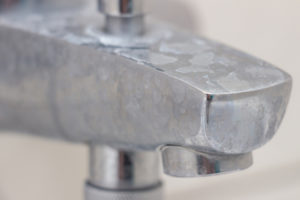 image of hard water stains on bathroom faucet