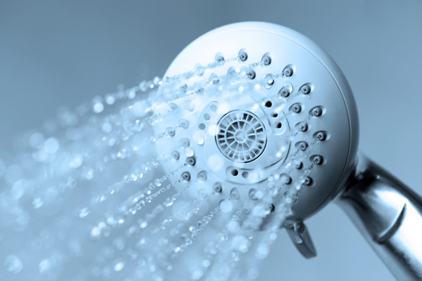 image of a showerhead depicting clogged shower drain