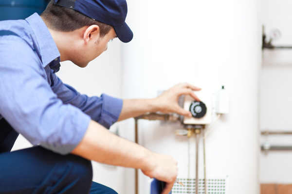 image of a plumber flushing a water heater