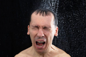 image of homeowner taking shower and running out of hot water