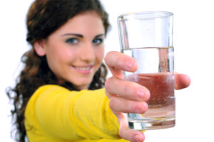 image of a homeowner holding a glass of drinking water