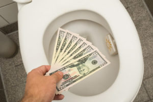 image of a running toilet and money depicting water waste
