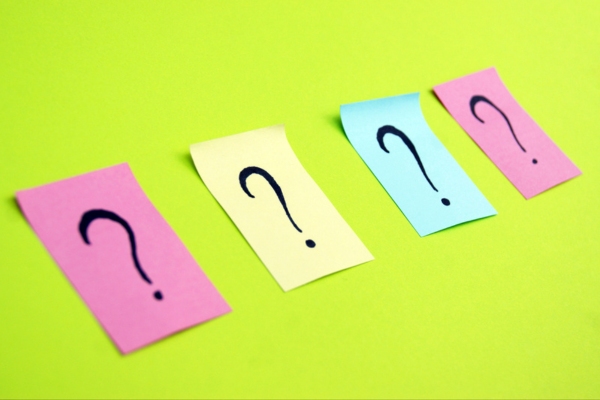 question marks on colored papers depicting Kitchen Sink Drain Smells Bad FAQs