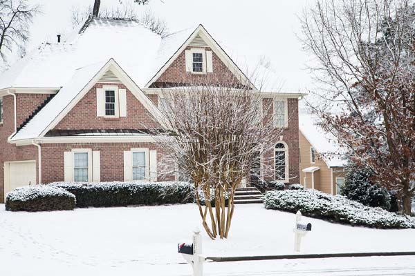 image of a snow-covered house in the lehigh valley that has winterized plumbing