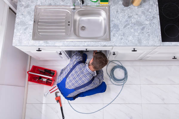 image of a plumbing removing airlock from water pipes in a home