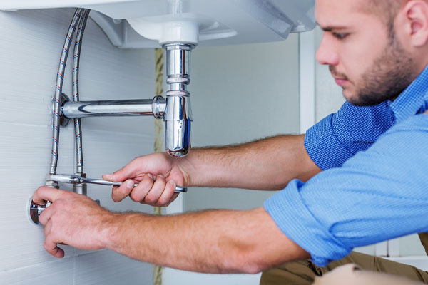professional plumber fixing pipes
