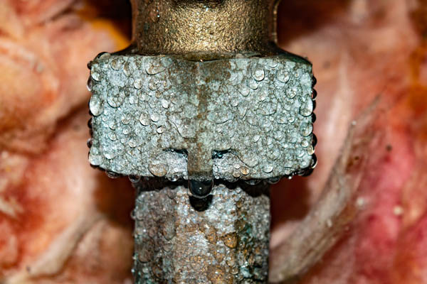 water dripping from a copper pipe