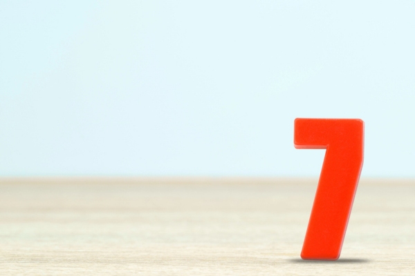 Shot of a number seven made of red plastic on table depicting Common Summer Plumbing Problems