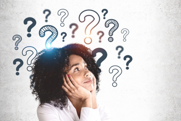 woman looking up to question marks depicting Summer Plumbing Concerns