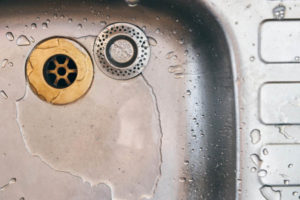 image of a kitchen sink drain depicting dropping something down sink drain