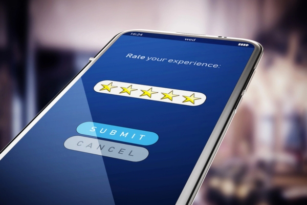 Five stars rating screen on smart phone depicting online reviews
