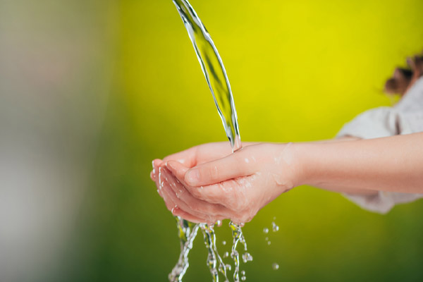 image of child hands holding water depicting conserve water concept