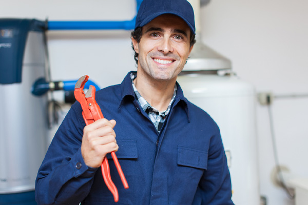 licensed plumber repairing a hot-water heater