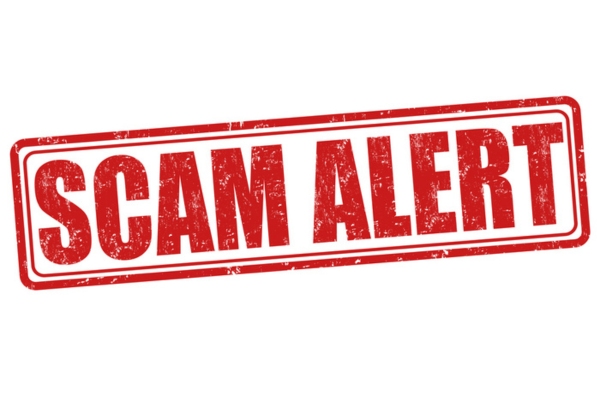 scam alert rubber stamp depicting plumbing scams