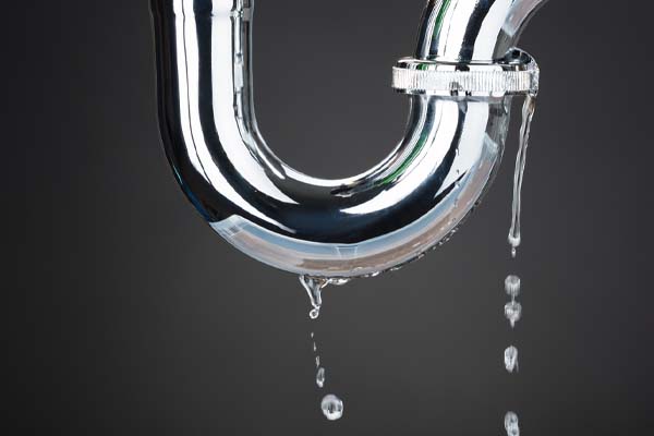 image of a leaking plumbing water pipe