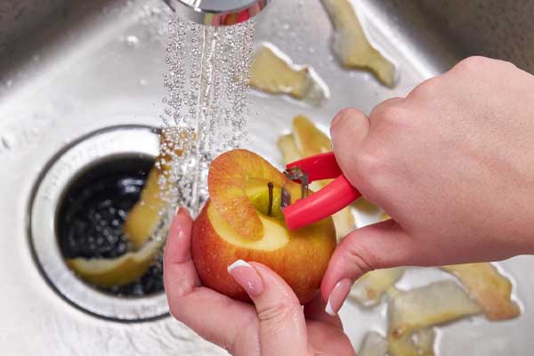 image of a homeowner using a garbage disposal