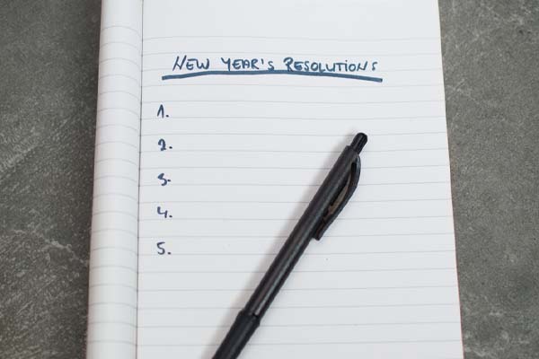 image of a person writing new years resolutions depicting plumbing resolutions for the new year