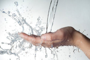 image of a hand cupping water depicting water-efficient home