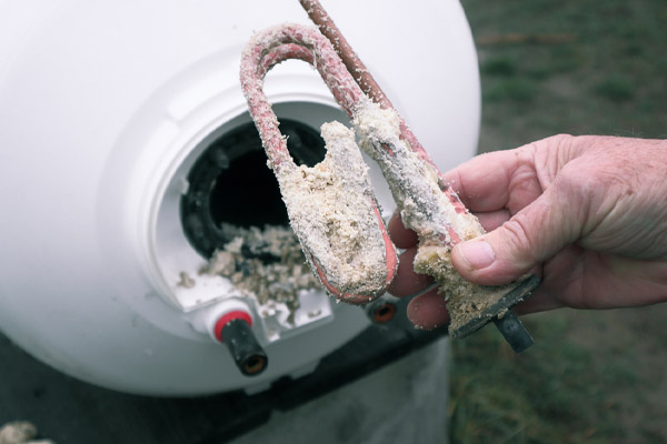 lime and mineral deposits on stainless steel heating element from on-demand water heater