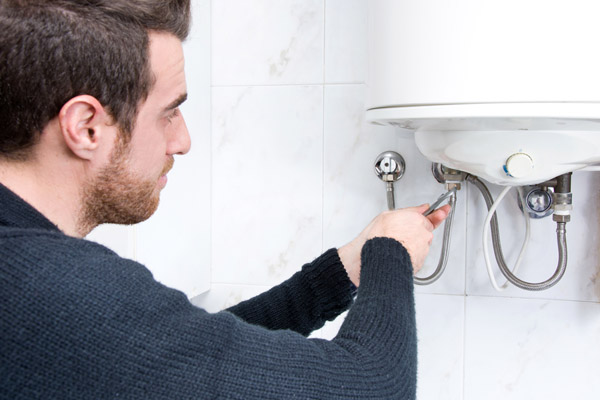 plumber fixing electric tankless water heater