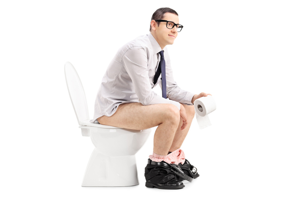 image of a man sitting on a toilet