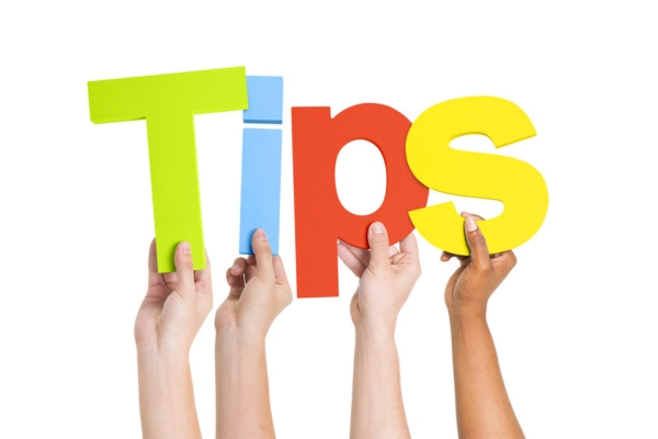 TIPS spelled using colorful cutout letters raised by different hands