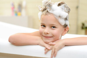 girl in bathtub depicting water safety tips for families