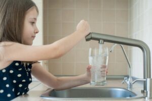 girl getting safe tap water for drinking