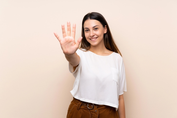 woman holding five fingers up depicting 5 Things To Try If Your Toilet Is Continuously Running