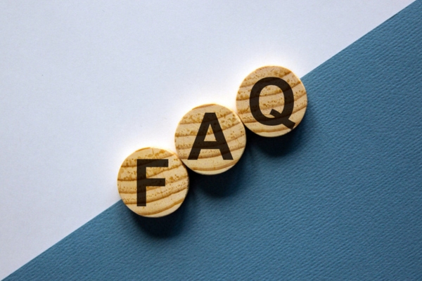 Wood circles with word FAQ depicting questions About Shower Upgrades