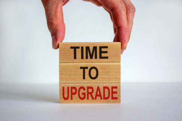 man completing the phrase time to upgrade using wooden blocks depicting bathroom plumbing
