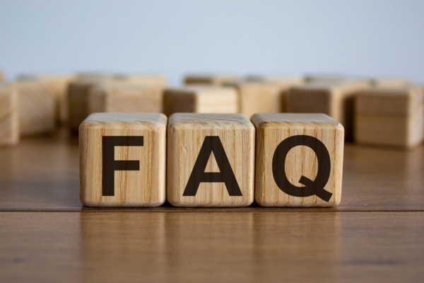 FAQ spelled using wooden letter cubes on top of a table depicting Water Pressure in Summer questions