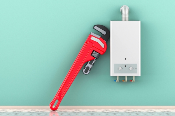 wrench beside a tankless water heater depicting maintenance